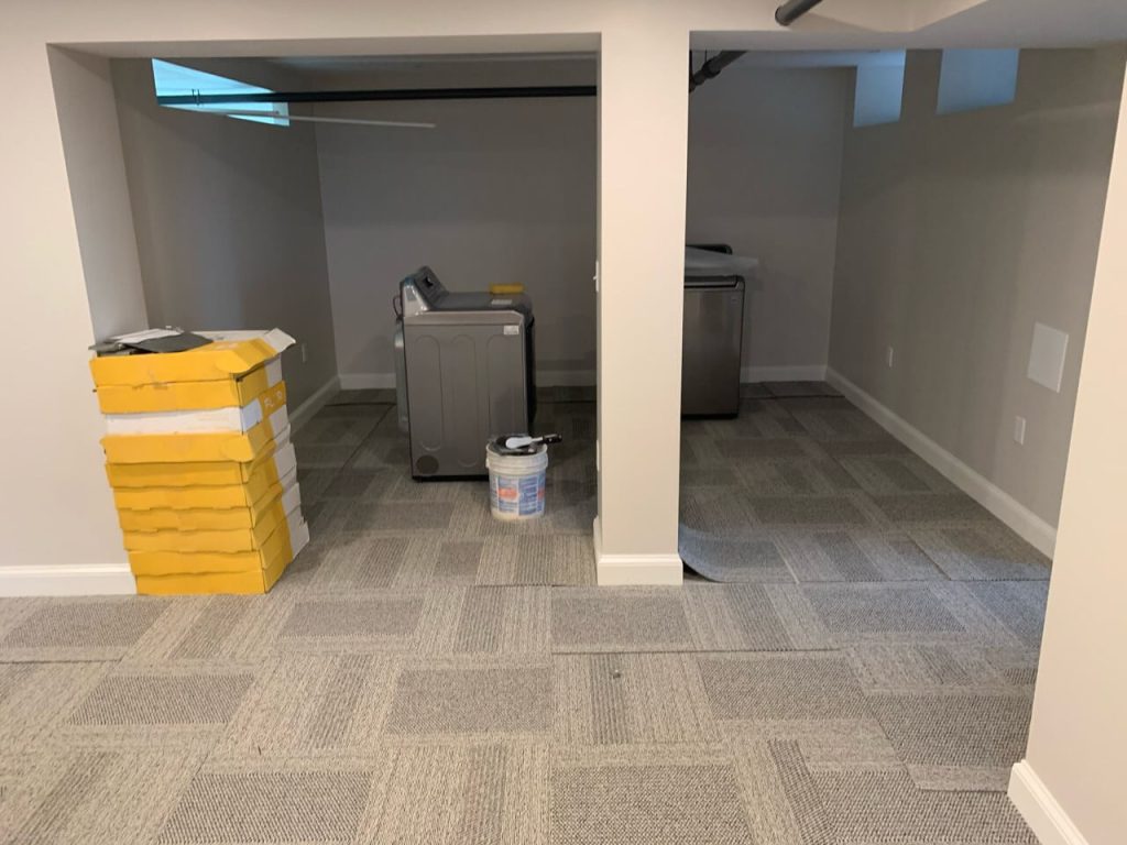 Basement Remodel laying down carpet tiles